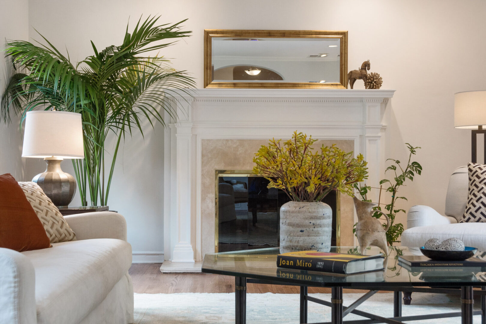 A living room with a fireplace and plants